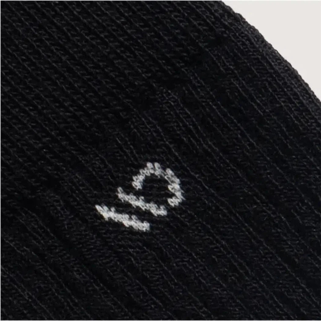 Black Wide Open Men's Solid Cushioned Micro Crew Socks close up showing the logo on the fabric.