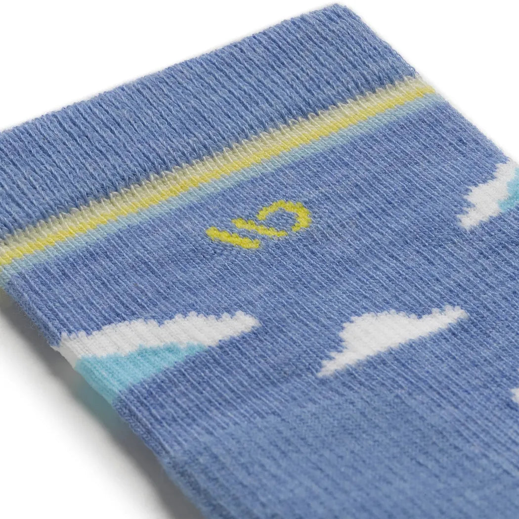 A close-up of the Wide Open Women's Cloud Hopper Midweight Micro Crew Sock in Sky, showing the yellow "16" logo and white cloud patterns against a blue background.