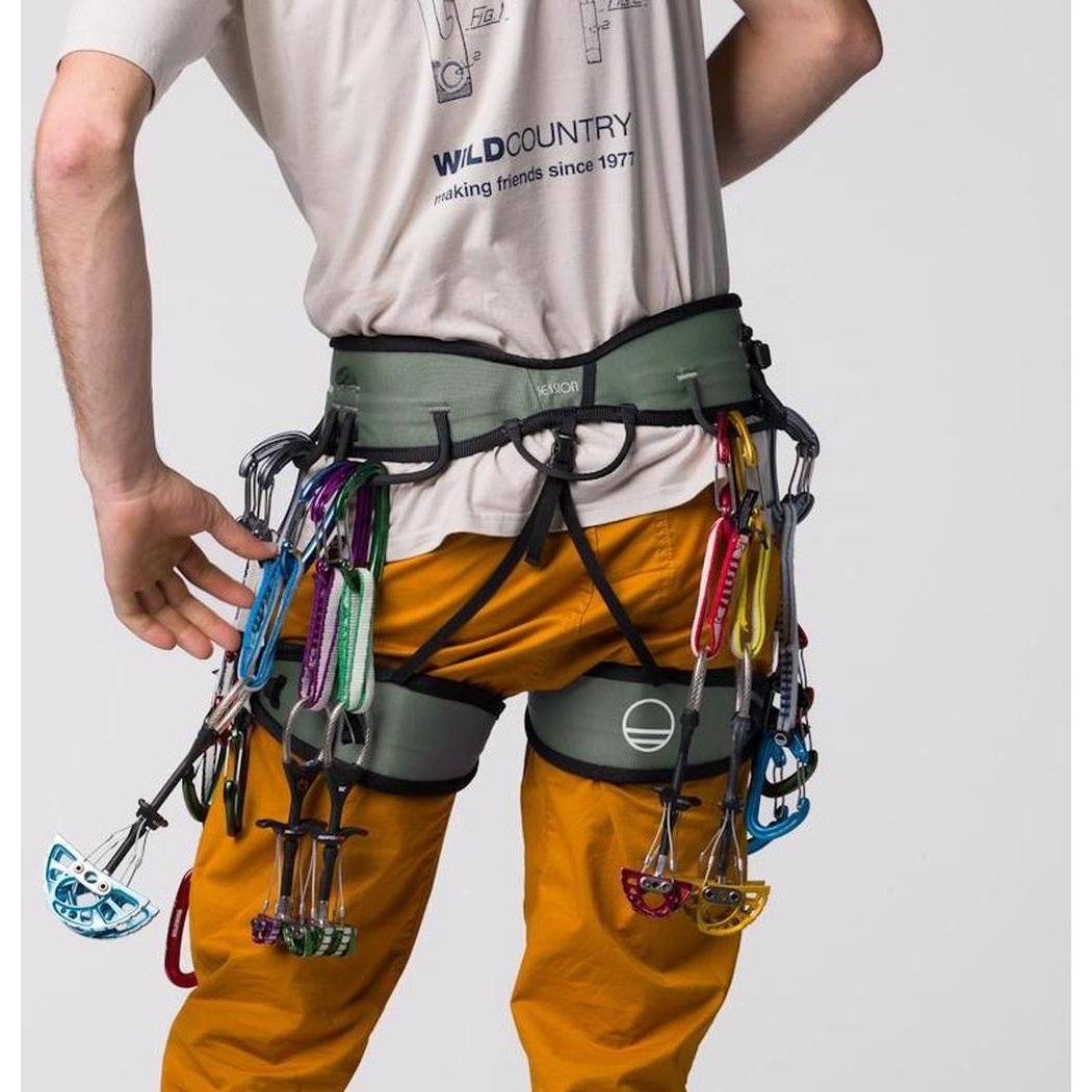 A man wearing the Wild Country Session 2.0 Men's harness with colorful carabiners, shown from the back against a plain background.