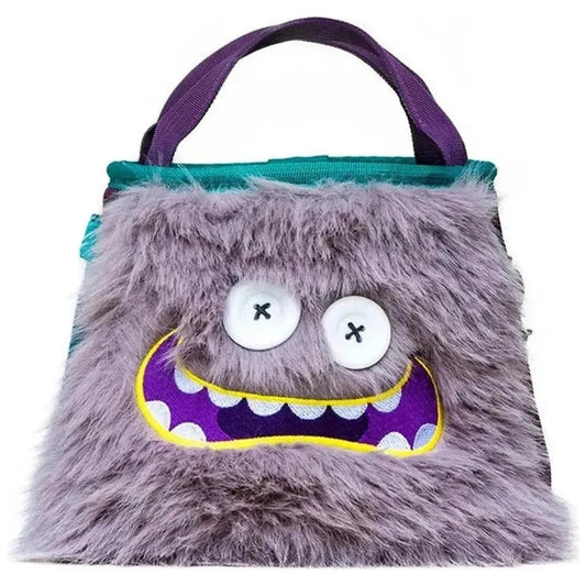 A front view of the 8BPlus Boulder Bucket - Angus chalk bag with a fuzzy charcoal exterior, large white eyes with X's, and a purple mouth with yellow trim, against a white background.