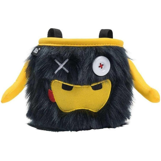 A front view of the 8BPlus Chalk Bag - Phil with a black and yellow furry design, white button eye, and yellow straps against a white background.