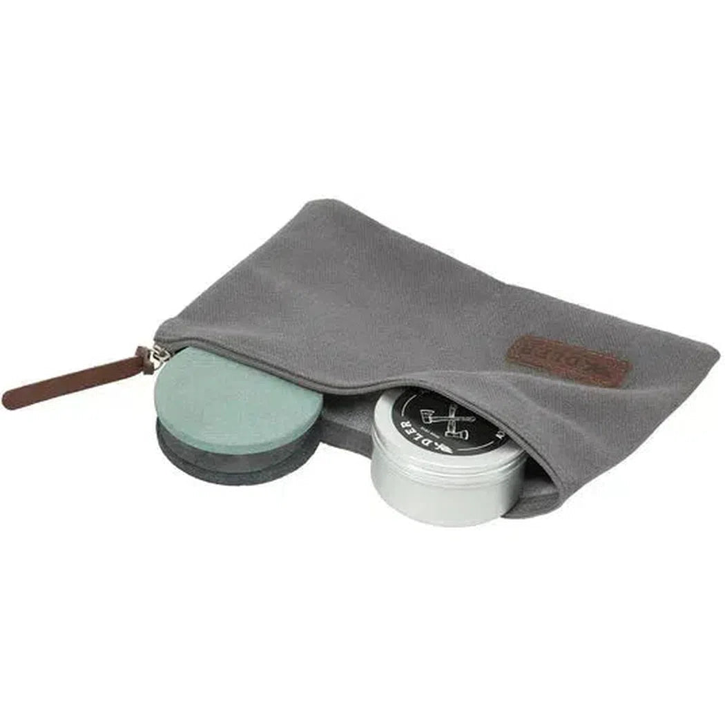 A gray Adler Axe Utility Set pouch with a brown zipper pull holds a green and black item and a silver tin, shown from a top-down angle against a white background.