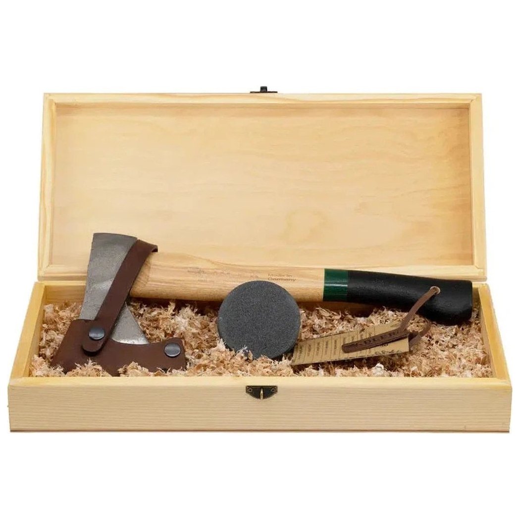 A wooden box containing the Adler Hatchet Gift Set - Rheinland Hatchet with a green and black handle, a small axe, and a sharpening stone.