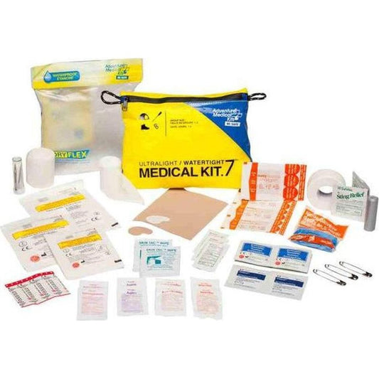 A yellow and blue Adventure Ready Brands AMK Ultralight/Watertight .7 medical kit laid out with bandages and supplies on a white background.