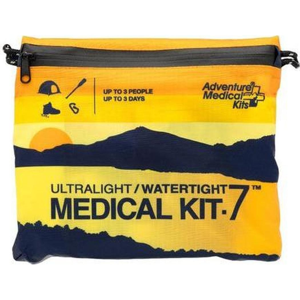 A front view of the Adventure Medical Kits Ultralight/Watertight Medical Kit - 7 with a mountain sunset graphic on a yellow and navy bag.