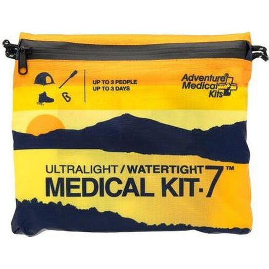 A front view of the Adventure Medical Kits Ultralight/Watertight Medical Kit - 7 with a mountain sunset graphic on a yellow and navy bag.