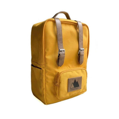 A front view of the Adventurist Backpack Co. Classic Backpack in Adobe color showing the front pocket and buckle straps against a white background.