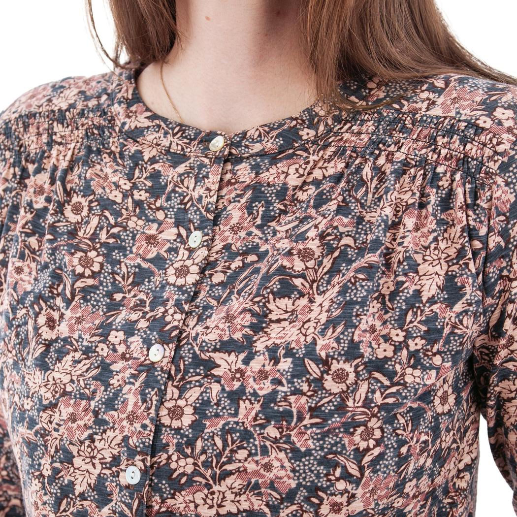 A close-up of the Aventura Women's Amaryllis Top in Atlantic Deep, showing the button-front design and floral pattern on a model.