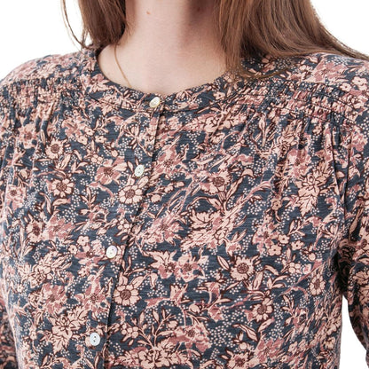 A close-up of the Aventura Women's Amaryllis Top in Atlantic Deep, showing the button-front design and floral pattern on a model.