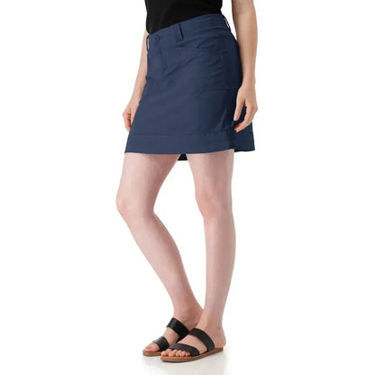 A side view of the Aventura Women's Arden V2 Skort in Granite Green on a model wearing black sandals against a white background.