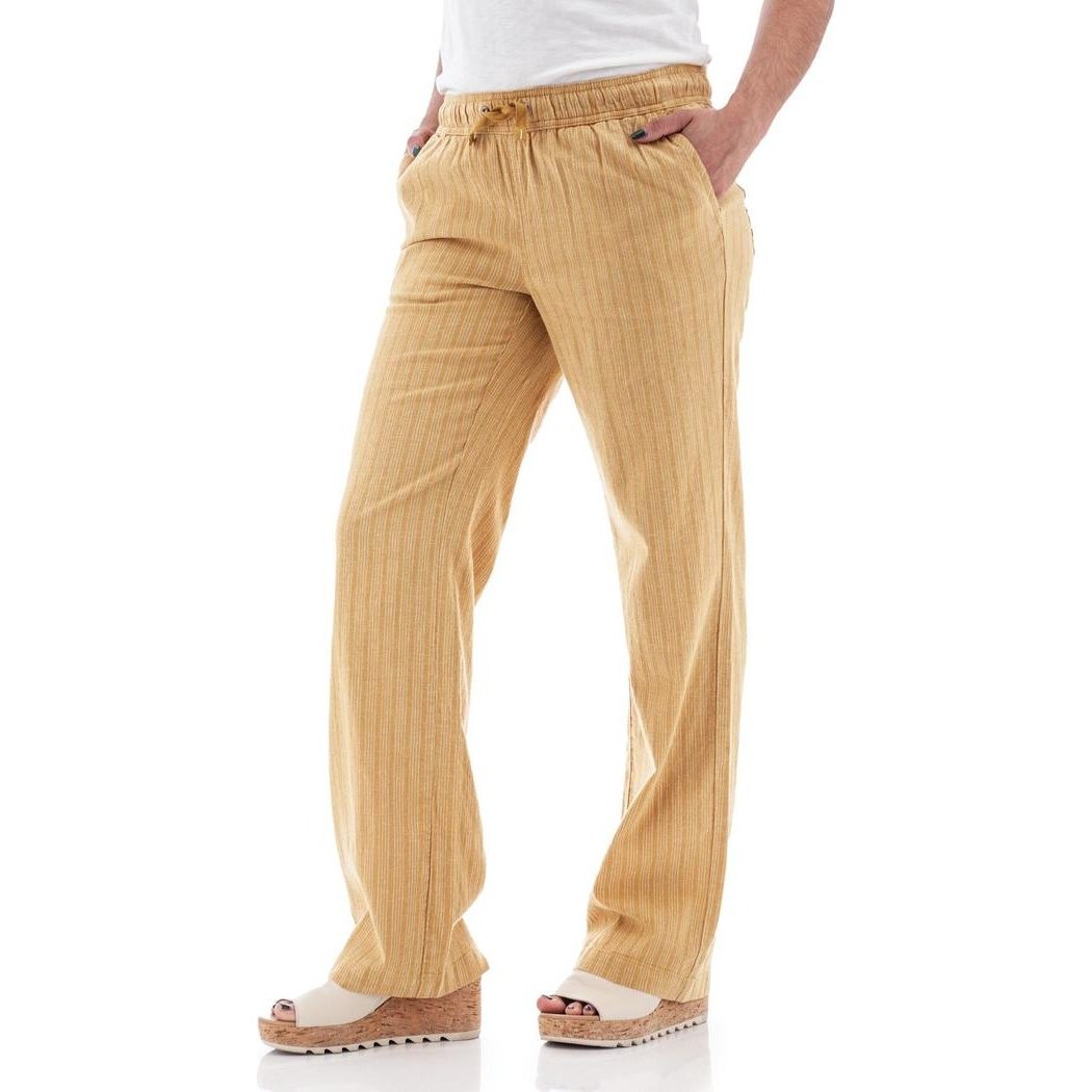 Side view of the Aventura Women's Breeze Pant in Amber Gold showing the elastic waistband and pockets against a white background.