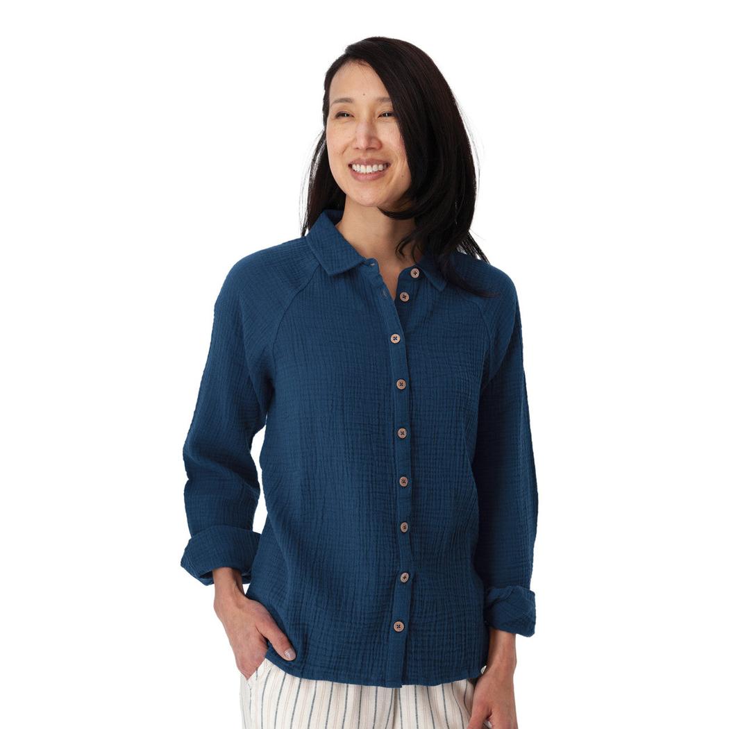 A woman wearing the Aventura Women's Kelford Full Button in Gibraltar Sea stands against a white background.