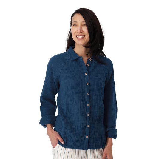 A woman wearing the Aventura Women's Kelford Full Button in Gibraltar Sea stands against a white background.