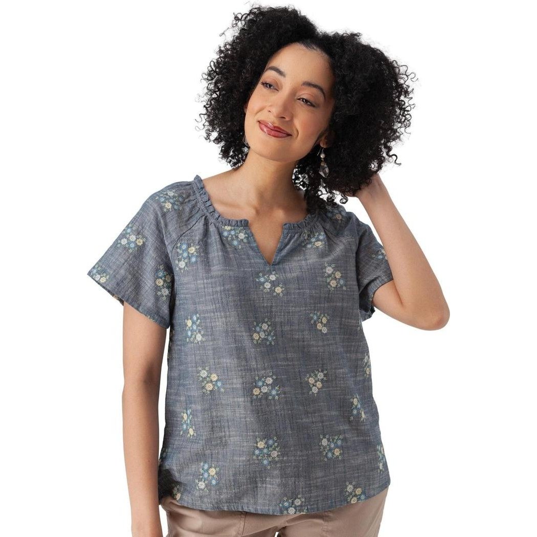 A woman wearing the Aventura Women's Mariposa Top in Gibraltar Sea poses against a white background.
