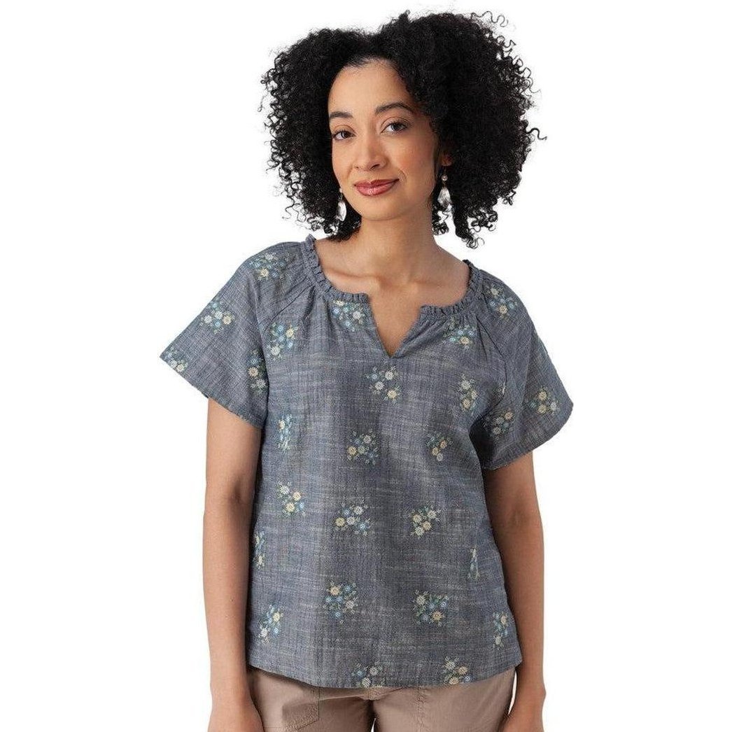 A woman wearing the Aventura Women's Mariposa Top in Gibraltar Sea stands against a white background.