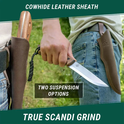 A person holds the Beavercraft BSH1 Bushcraft Knife with its cowhide leather sheath visible, against a green outdoor background.