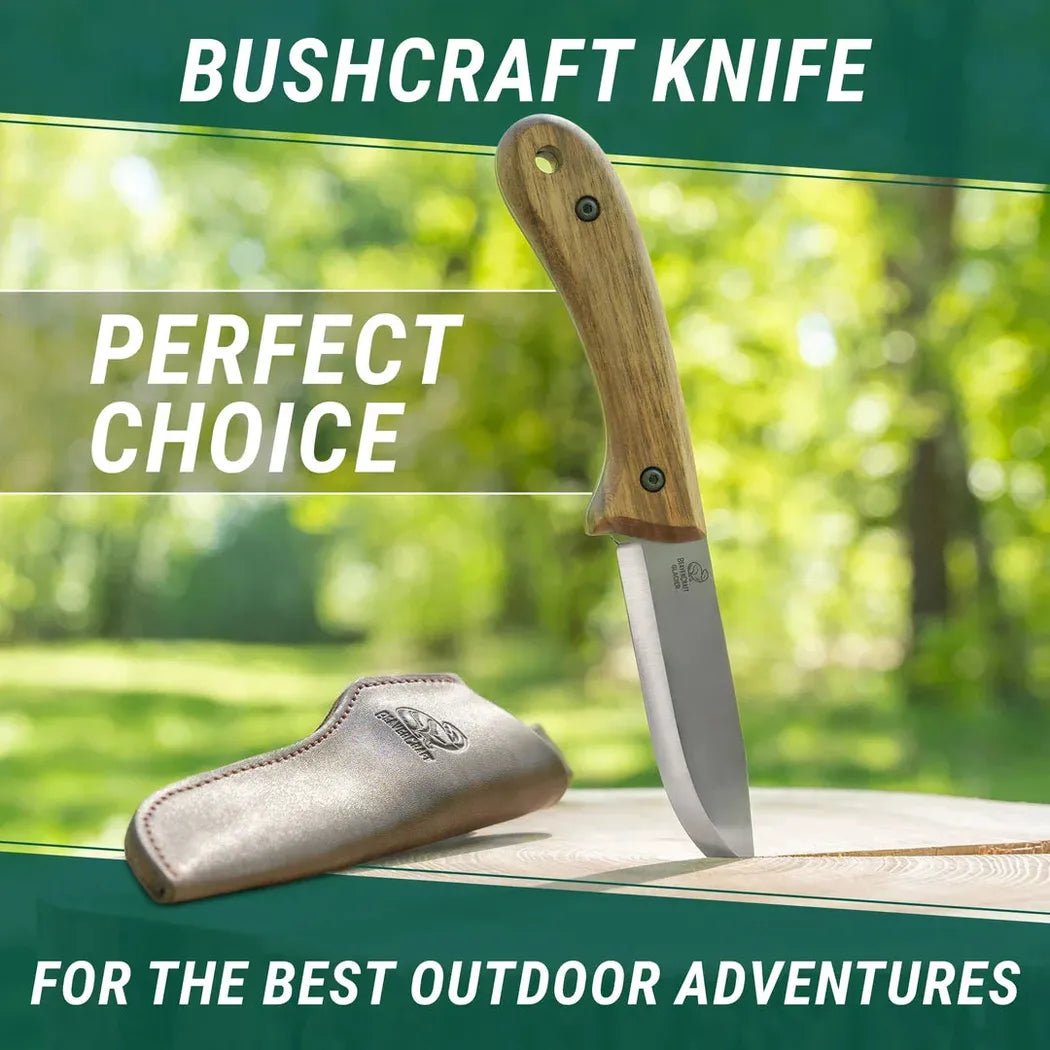 A bushcraft knife with a wooden handle and leather sheath sits on a wooden surface against a green outdoor background.