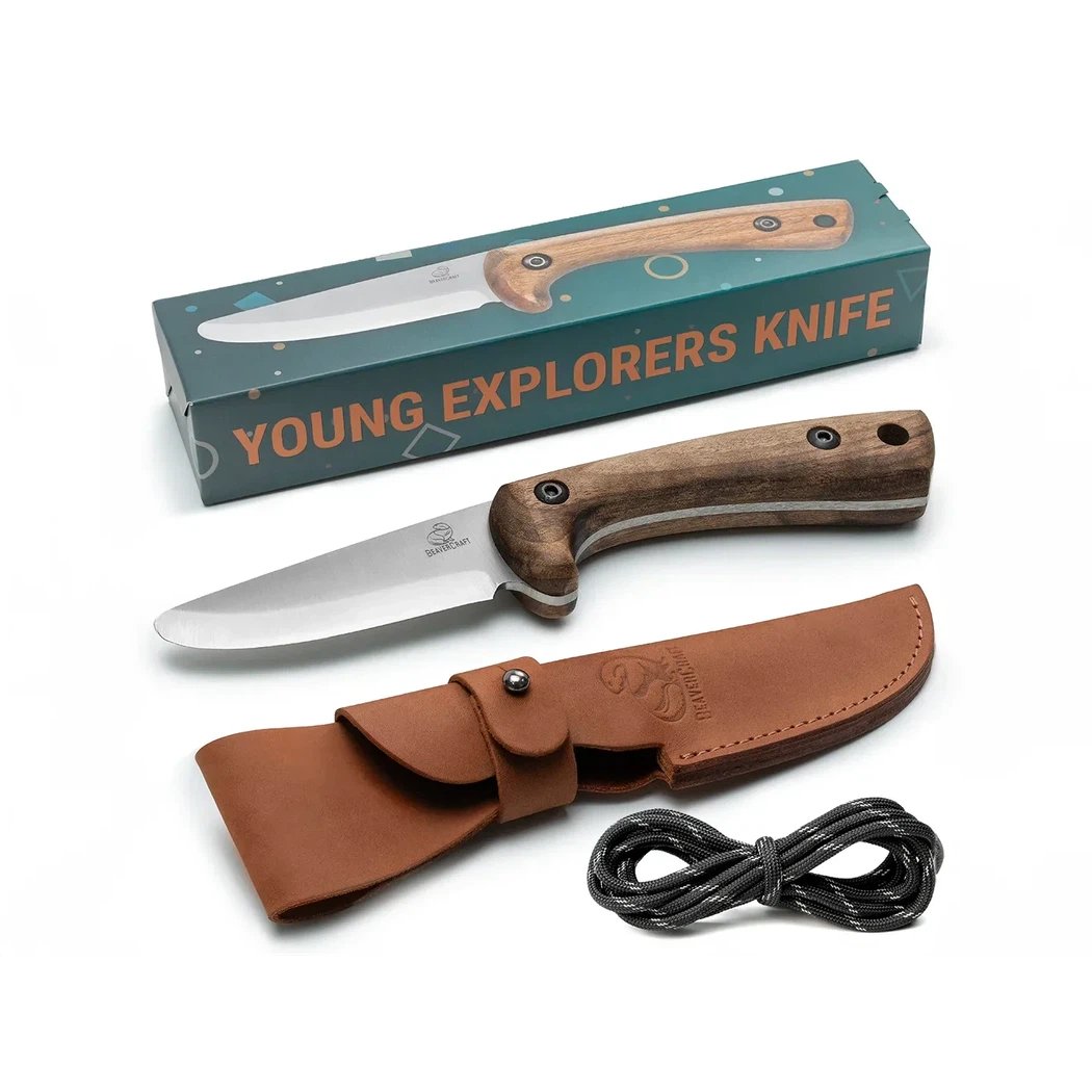 A top-down view of the Beavercraft Carbon Steel Blued-Blade Bushcraft Knife for Kids with its brown leather sheath and black cord on a white background.