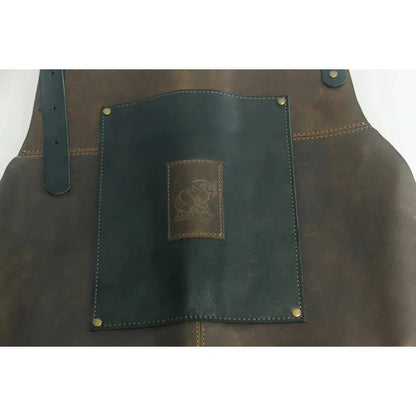 A close-up of the Beavercraft Cowhide Apron Leather showing the dark pocket panel and brass rivets against a brown leather background.