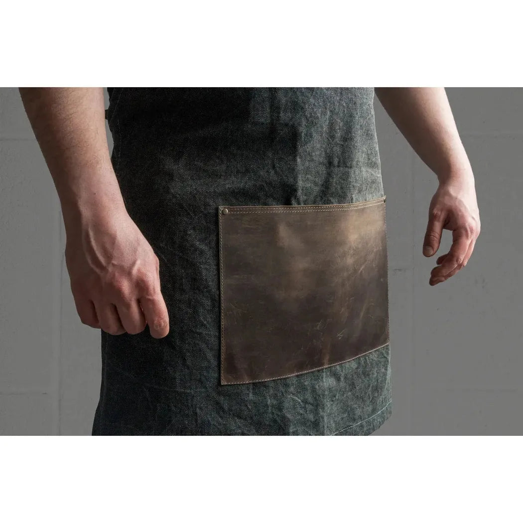 Side view of the Beavercraft Cowhide Apron Leather with a large leather pocket against a gray background.