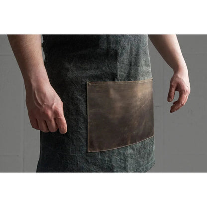 Side view of the Beavercraft Cowhide Apron Leather with a large leather pocket against a gray background.