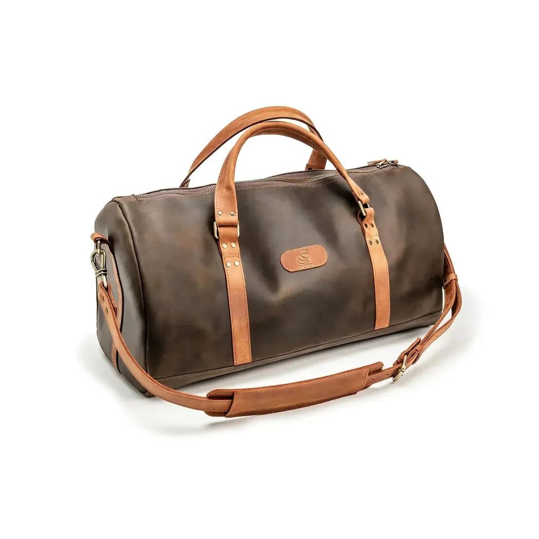 A front view of the Beavercraft Journey - Leather Travel Luggage Duffel Bag in Chocolate with tan straps and a shoulder strap against a white background.