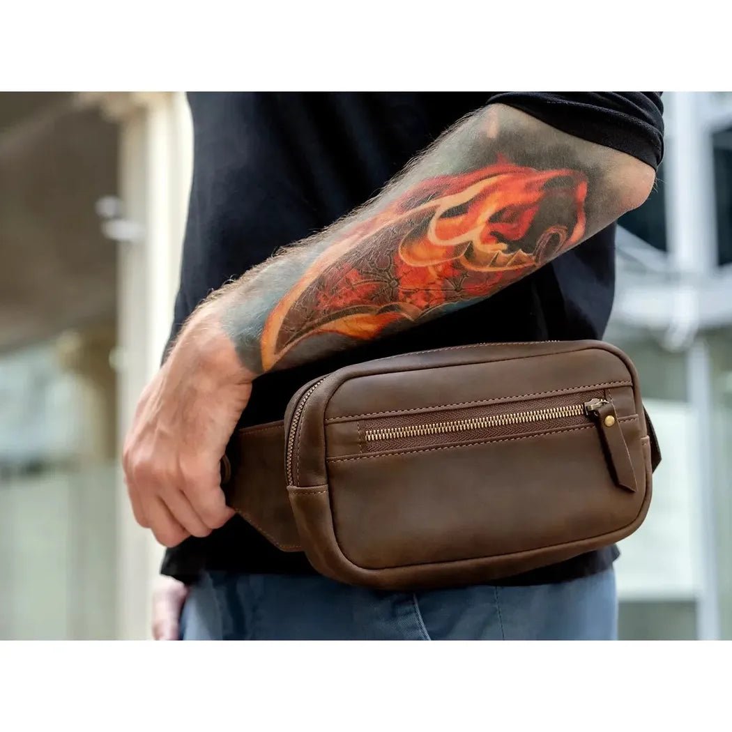 A man with a colorful tattoo on his arm wears the brown Beavercraft Quest leather waist bag in a side view.