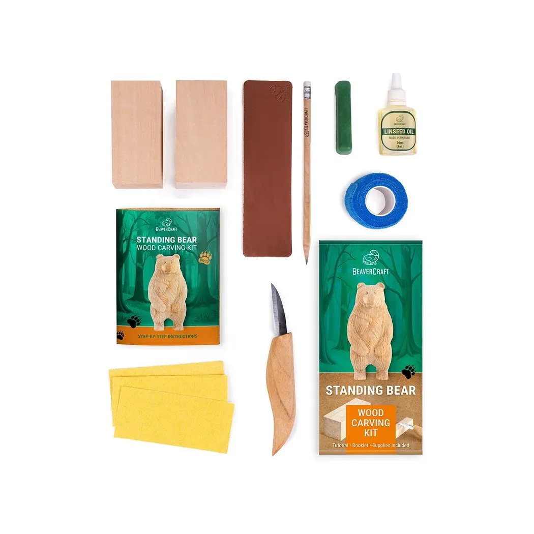 A top-down view of the Beavercraft Standing Bear Wood Carving kit showing the tools and materials against a white background.