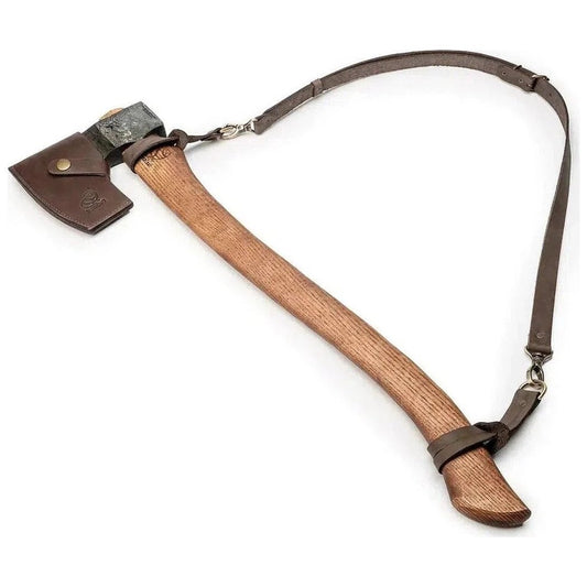 A natural wood-handled Beavercraft Universal Forest Felling Axe with a charcoal/ graphite head and leather sheath strap, shown from a side angle against a white background.