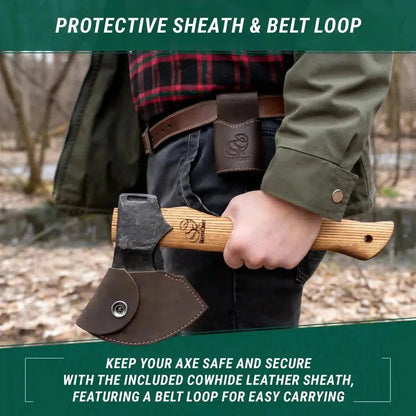 A person wearing a green jacket holds a Beavercraft Woodcraft Bushcraft Splitting Hatchet with a protective sheath and belt loop, against a wooded background.