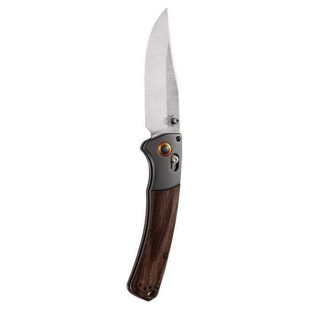 A side view of the Benchmade 15080-2 Crooked River knife with a wooden handle and charcoal/ graphite accents against a white background.