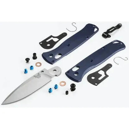 A disassembled Benchmade Bugout knife with blue handles and a silver blade laid out on a white background.
