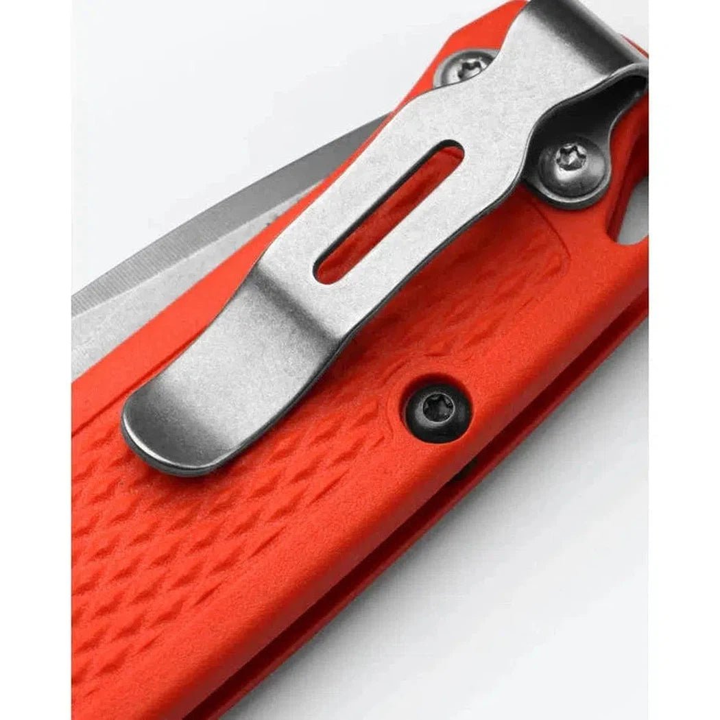Close-up of the Benchmade Mini Bugout knife with its orange handle and metal clip, photographed against a white background.