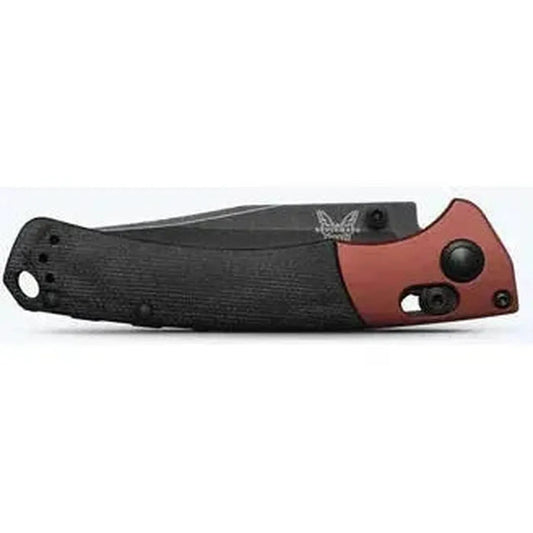 Side view of the Benchmade Mini Crooked River knife with black and red handle against a white background.