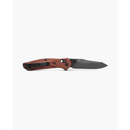 A side view of the Benchmade Mini Osborne knife with a red handle and black blade against a plain white background.