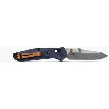 A side view of the Benchmade Mini Osborne knife with a charcoal/gray handle and a silver blade against a white background.