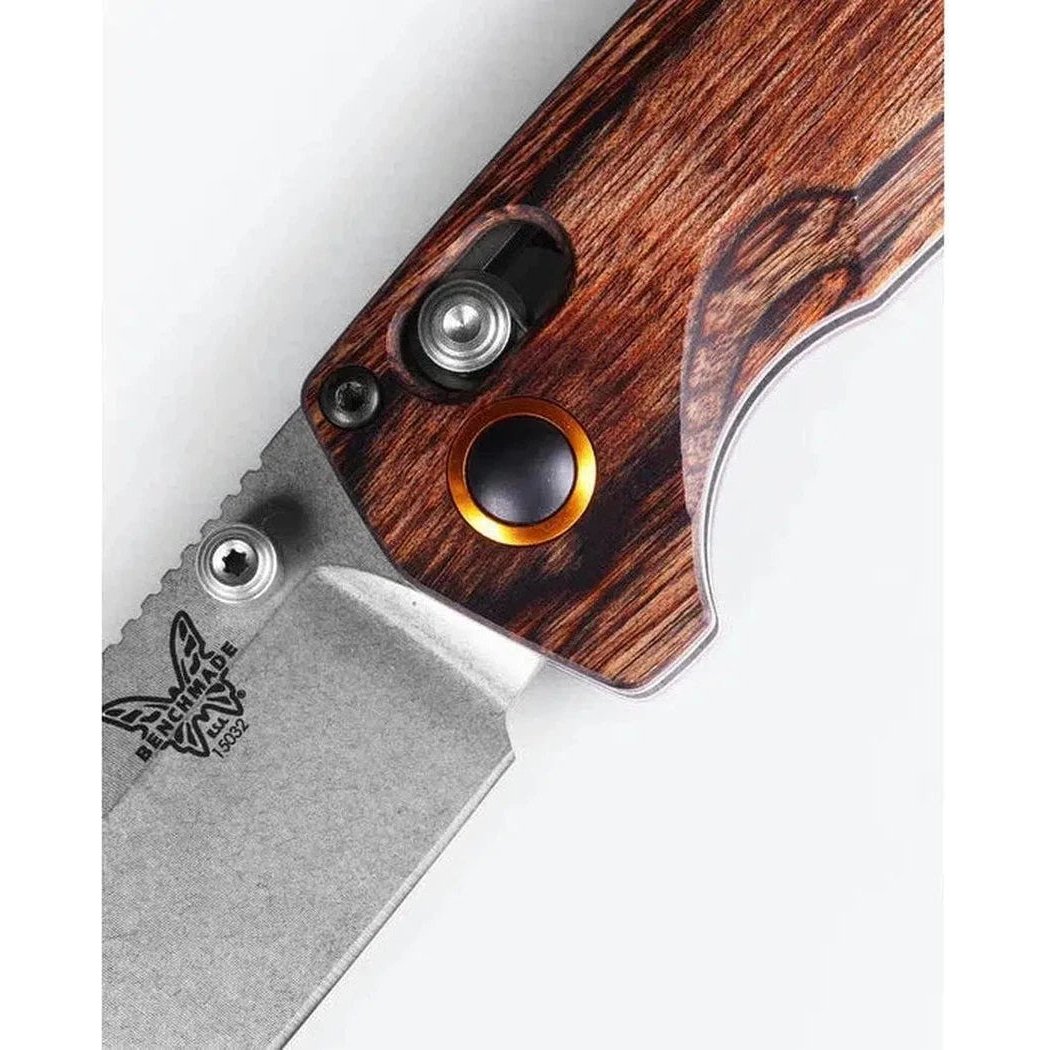 A close-up of the Benchmade North Fork with maple stabilized wood handle and a silver blade, showing the logo and a white background.