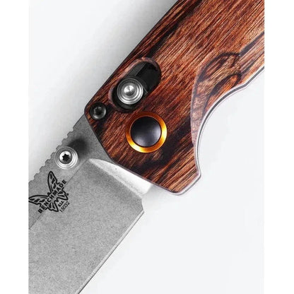 A close-up of the Benchmade North Fork with maple stabilized wood handle and a silver blade, showing the logo and a white background.