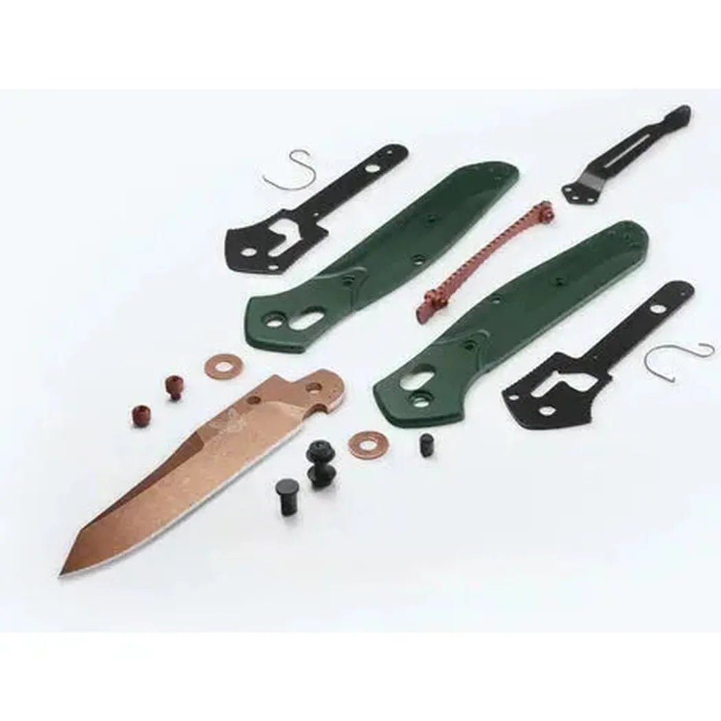 A top-down view of the Benchmade Osborne knife kit with green handles, a copper blade, and black metal parts on a white background.