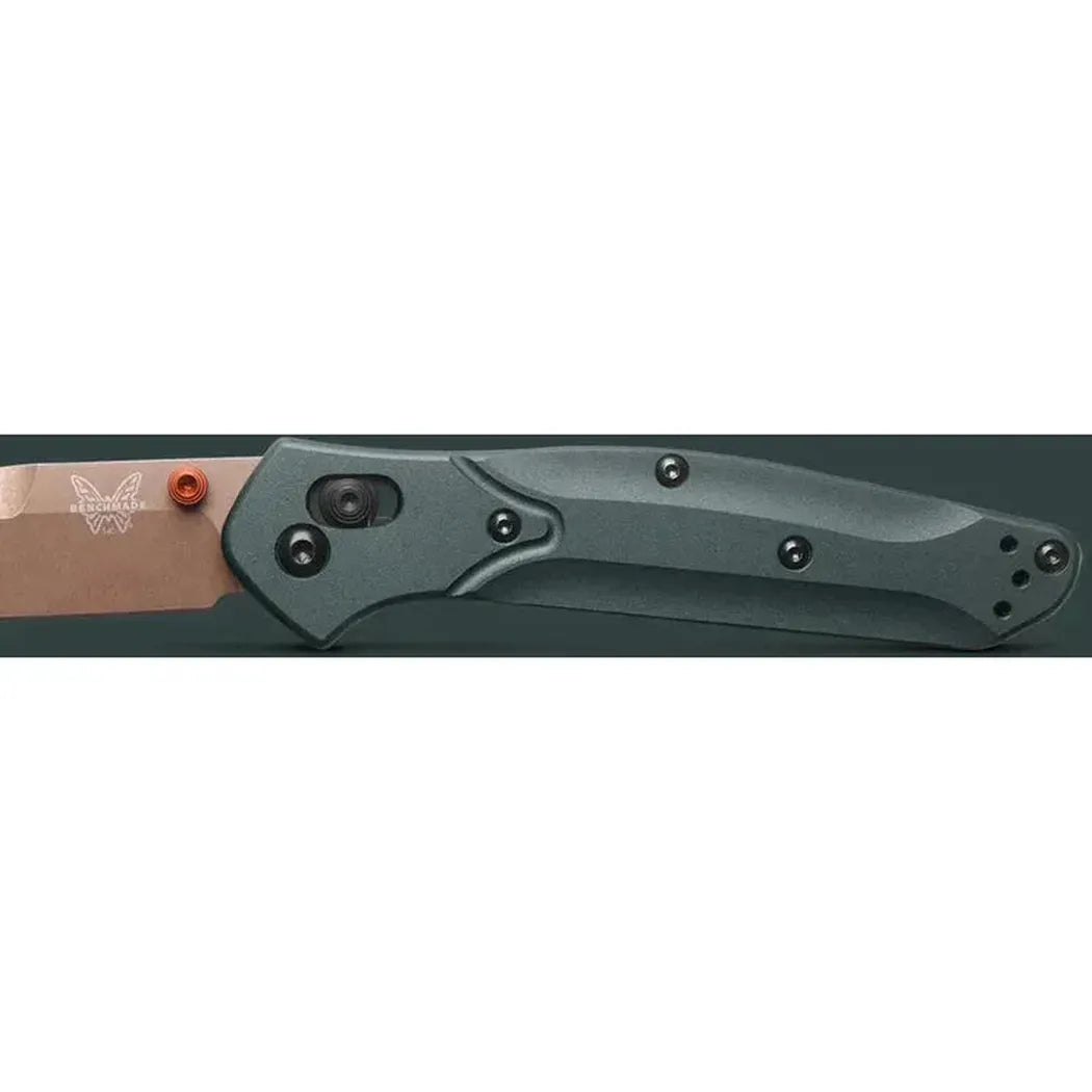A side view of the Benchmade Osborne knife with a charcoal/gray handle and copper-colored blade, showing the pocket clip and pivot mechanism against a dark background.