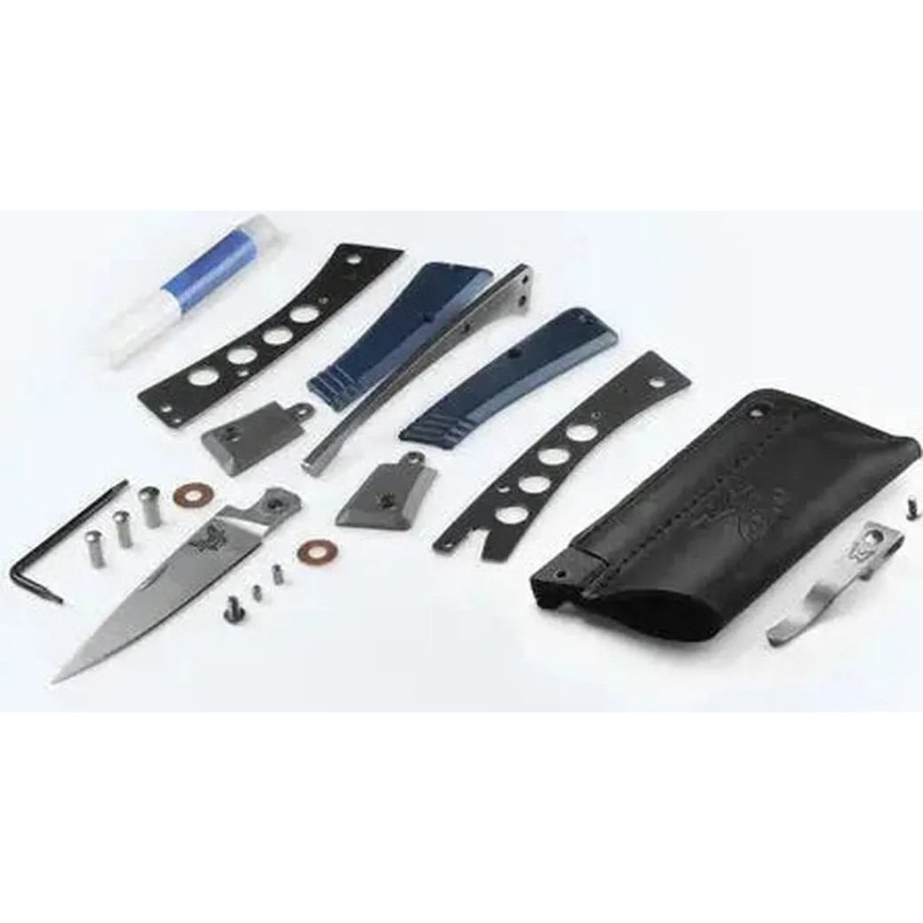 A top-down view of the Benchmade Successor knife kit with its black leather sheath and various components laid out on a white background.