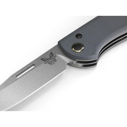 A close-up side view of the Benchmade Weekender knife with a charcoal/gray handle and a silver blade, showing the logo and a lanyard hole against a white background.