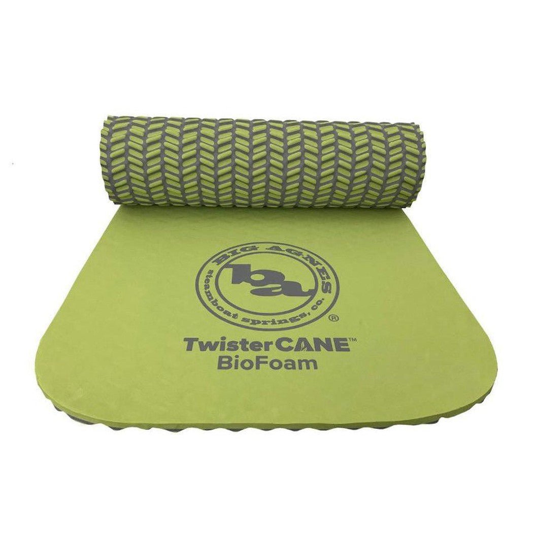 A rolled green Big Agnes TwisterCane Bio Foam pad with a logo on the unrolled section against a white background.