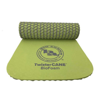 A rolled green Big Agnes TwisterCane Bio Foam pad with a logo on the unrolled section against a white background.