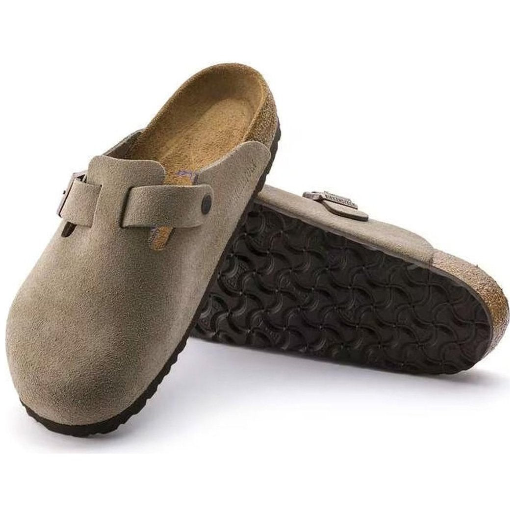 Side view of the Birkenstock Boston Soft Footbed - Suede Leather in Taupe showing the buckle strap and textured outsole against a white background.