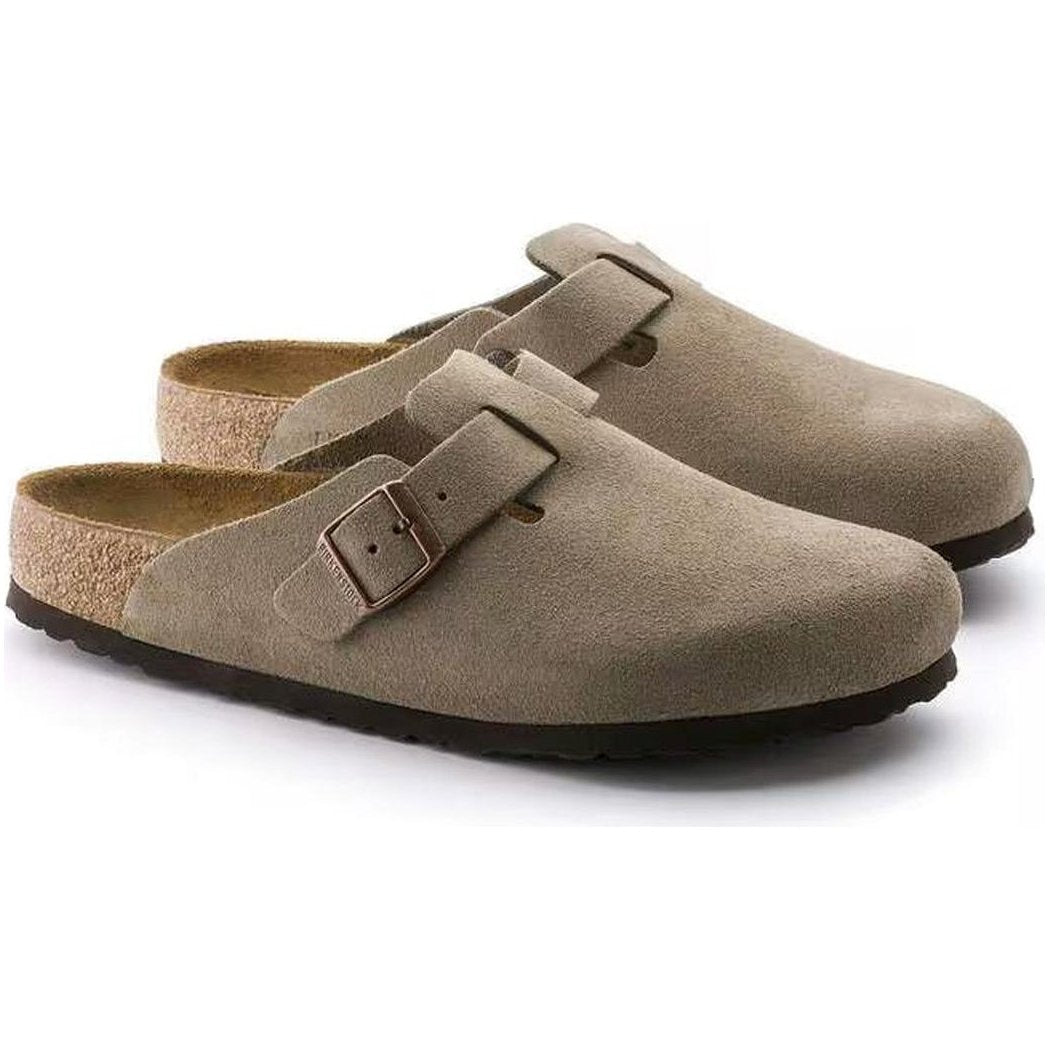 Side view of the Birkenstock Boston Soft Footbed - Suede Leather in Taupe showing the buckle and cork footbed against a white background.