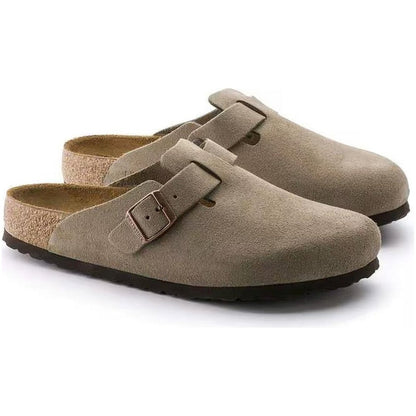 Side view of the Birkenstock Boston Soft Footbed - Suede Leather in Taupe showing the buckle and cork footbed against a white background.