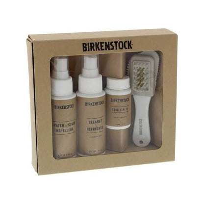 A brown Birkenstock Deluxe Shoe Care Kit box with three spray bottles and a brush inside, photographed from the front against a white background.