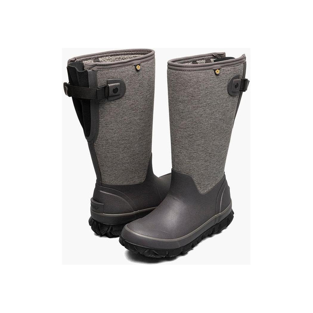 Side view of the Bogs Footwear Women's Whiteout Adjustable Calf - Heather boots in Gray with adjustable straps and a black rubber sole against a white background.