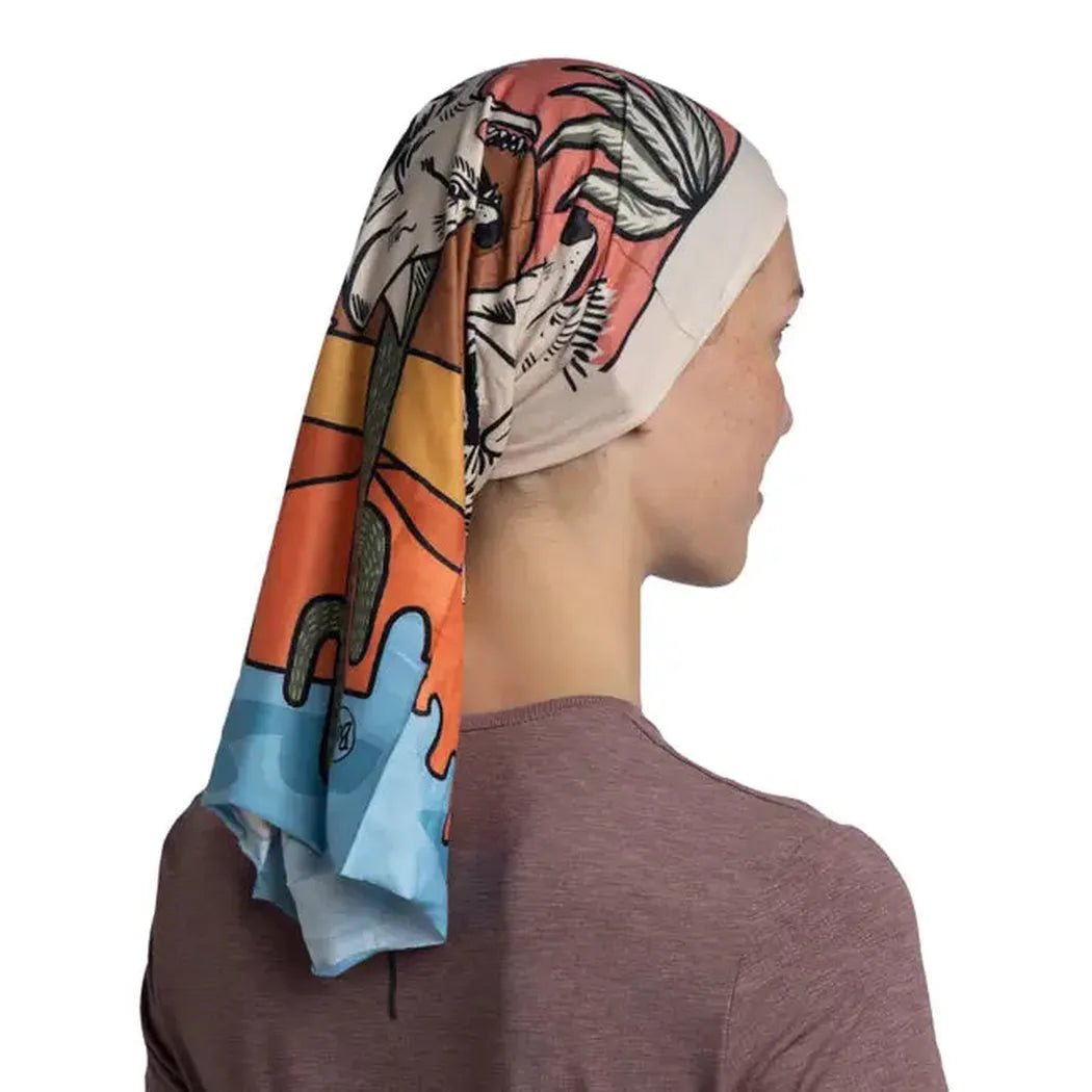 Side view of the Buff CoolNet UV - Amino bandana on a model wearing a charcoal shirt against a white background.